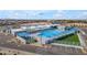 Aerial shot of fenced-in community pool area, with slides, lap lanes, and outdoor seating at 151 N 116Th Dr, Avondale, AZ 85323