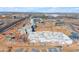 Aerial view of construction site featuring roller coaster, hotel, and highway at 151 N 116Th Dr, Avondale, AZ 85323