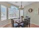 Sunlit dining room featuring a chandelier, a big window, and seating for six at 151 N 116Th Dr, Avondale, AZ 85323