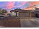 Charming single-story home featuring a two-car garage, low maintenance desert landscaping, and a tile roof at 151 N 116Th Dr, Avondale, AZ 85323