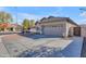 Charming single-story home featuring a two-car garage, low maintenance desert landscaping, and a wide driveway at 151 N 116Th Dr, Avondale, AZ 85323