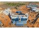 Aerial view of hotel construction site featuring various buildings, parking, and a stadium in the distance at 151 N 116Th Dr, Avondale, AZ 85323