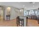 Bright kitchen area with a breakfast bar, granite countertops, stainless appliances, and tile flooring at 151 N 116Th Dr, Avondale, AZ 85323