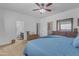 Spacious bedroom featuring a ceiling fan, ensuite bath and an attractive wooden dresser with mirror at 151 N 116Th Dr, Avondale, AZ 85323