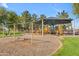 Community playground featuring swings and slides, and climbing structure under a sunshade at 151 N 116Th Dr, Avondale, AZ 85323