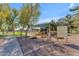 Community playground featuring a colorful play structure under a sunshade and mature shade trees at 151 N 116Th Dr, Avondale, AZ 85323