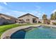 Relaxing pool with a rock waterfall feature and plenty of space for entertaining at 151 N 116Th Dr, Avondale, AZ 85323