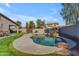 Inviting backyard pool with rock waterfall, lush lawn, and shaded patio for outdoor enjoyment at 151 N 116Th Dr, Avondale, AZ 85323