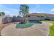 Backyard pool featuring a rock waterfall and desert landscaping offering a refreshing outdoor experience at 151 N 116Th Dr, Avondale, AZ 85323