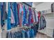 Well-organized walk-in closet with ample storage and a variety of clothing at 151 N 116Th Dr, Avondale, AZ 85323