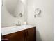 Well-lit powder room featuring marble countertop, dark wood vanity, and modern mirror at 1600 N Saba St # 191, Chandler, AZ 85225