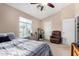 This bedroom features a ceiling fan, closet, windows with blinds, and a warm color palette at 1600 N Saba St # 191, Chandler, AZ 85225