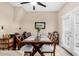 Inviting dining room features a long table, seating for eight, and natural light from the French doors at 1600 N Saba St # 191, Chandler, AZ 85225