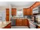 Well lit kitchen with an island, stainless steel appliances, granite countertops, and wood cabinets at 1600 N Saba St # 191, Chandler, AZ 85225