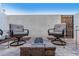 Patio with comfortable seating centered around a built in fire pit and a privacy wall at 1600 N Saba St # 191, Chandler, AZ 85225