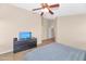 Spacious bedroom with ceiling fan, tile floors, and window blinds at 16102 W Miami St, Goodyear, AZ 85338