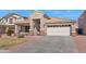 Beautiful home with a well-maintained lawn and a spacious two-car garage at 16102 W Miami St, Goodyear, AZ 85338