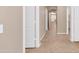 Neutral hallway featuring tile floors and white doors at 16102 W Miami St, Goodyear, AZ 85338