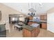 Open-concept kitchen with granite countertops, island, and stainless steel appliances at 16102 W Miami St, Goodyear, AZ 85338