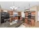 Bright kitchen with wooden cabinetry, granite countertops, and modern black appliances at 16102 W Miami St, Goodyear, AZ 85338