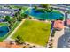 Aerial view showcases a lush green lawn bowling area, pond with fountain, and parking near the community building at 1612 Leisure World --, Mesa, AZ 85206