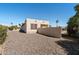 Beige single-story home featuring a decorative stone yard and a stucco wall for added privacy and aesthetic appeal at 1612 Leisure World --, Mesa, AZ 85206