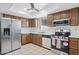 This modern kitchen features stainless steel appliances, including a refrigerator, oven, and microwave at 1612 Leisure World --, Mesa, AZ 85206