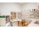 Bright studio features shelving with paint supplies, cabinets, sink, and storage at 1612 Leisure World --, Mesa, AZ 85206