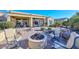 Inviting backyard patio features an outdoor fireplace and comfortable seating at 16409 W Alvarado Dr, Goodyear, AZ 85395