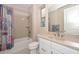 Bright bathroom features a shower-tub combo, neutral tones, and a single sink vanity at 16409 W Alvarado Dr, Goodyear, AZ 85395