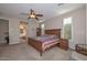 Bright bedroom with natural light, a ceiling fan, ensuite bathroom, and classic wood furniture at 16409 W Alvarado Dr, Goodyear, AZ 85395