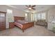 Bedroom with ceiling fan, natural light, wood furniture and carpeted floors at 16409 W Alvarado Dr, Goodyear, AZ 85395