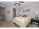 Inviting bedroom with carpet, neutral walls, a ceiling fan, and a quaint accent table at 16409 W Alvarado Dr, Goodyear, AZ 85395