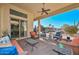 Inviting covered patio featuring comfortable seating and a ceiling fan for outdoor relaxation and entertaining at 16409 W Alvarado Dr, Goodyear, AZ 85395