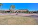 Residential back exterior featuring native landscaping and solar panels on roof at 16409 W Alvarado Dr, Goodyear, AZ 85395