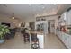 Open concept kitchen flowing into the living room and featuring granite countertops and stainless steel appliances at 16409 W Alvarado Dr, Goodyear, AZ 85395