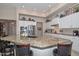 Kitchen island with granite countertops, white cabinets, and stainless steel appliances at 16409 W Alvarado Dr, Goodyear, AZ 85395