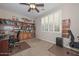 Home office area with wood bookshelves, a window with shutter blinds, and two desk setups at 16409 W Alvarado Dr, Goodyear, AZ 85395