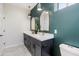 Gorgeous bathroom featuring a double sink vanity, green accent wall, and tiled floors at 1642 E Monte Vista Rd # 9, Phoenix, AZ 85006