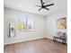 Minimalist bedroom with wood-look flooring, a ceiling fan, and natural light at 1642 E Monte Vista Rd # 9, Phoenix, AZ 85006