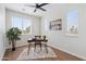 Bright bedroom featuring a ceiling fan, a cozy desk, and large windows with blinds at 1642 E Monte Vista Rd # 9, Phoenix, AZ 85006