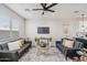 Well-lit living room with contemporary furnishings, ceiling fan, and an open view to kitchen at 1642 E Monte Vista Rd # 9, Phoenix, AZ 85006