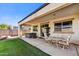 View of covered patio featuring hot tub, dining set, easy access to interior via sliding glass doors at 17138 W Las Palmaritas Dr, Waddell, AZ 85355