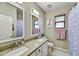 Bathroom featuring double sinks, bright lighting, and charming mermaid themed decor at 17138 W Las Palmaritas Dr, Waddell, AZ 85355