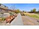 Well maintained community walkway with benches surrounded by mature trees and landscaping at 17138 W Las Palmaritas Dr, Waddell, AZ 85355