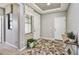 Inviting entryway with decorative flooring, a white front door, and neutral paint at 17138 W Las Palmaritas Dr, Waddell, AZ 85355