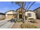 Charming single-Gathering home featuring stone accents, desert landscaping, and a welcoming facade at 17138 W Las Palmaritas Dr, Waddell, AZ 85355