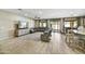 Spacious living room featuring tile floors, a large sectional sofa, and natural light at 17138 W Las Palmaritas Dr, Waddell, AZ 85355