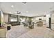 Open-concept living area with tile flooring, a comfortable seating arrangement, and a kitchen view at 17138 W Las Palmaritas Dr, Waddell, AZ 85355