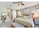 Relaxing main bedroom with a plush bed, stylish decor, and a sliding barn door leading to the en-suite bathroom at 17138 W Las Palmaritas Dr, Waddell, AZ 85355